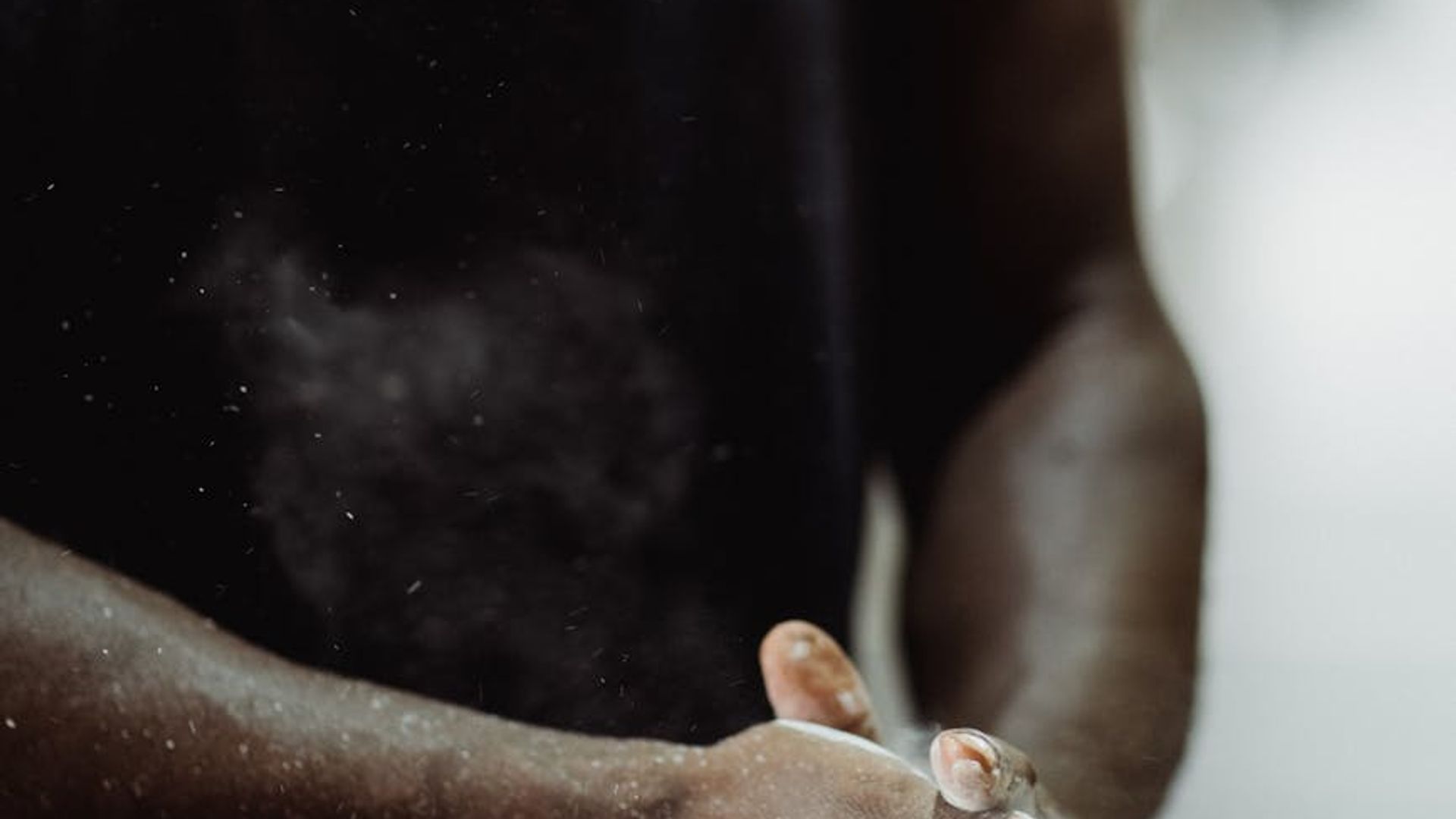 Man performing a strength exercise in a dark gym setting